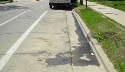 Fluid leaking from a van and running along the curb